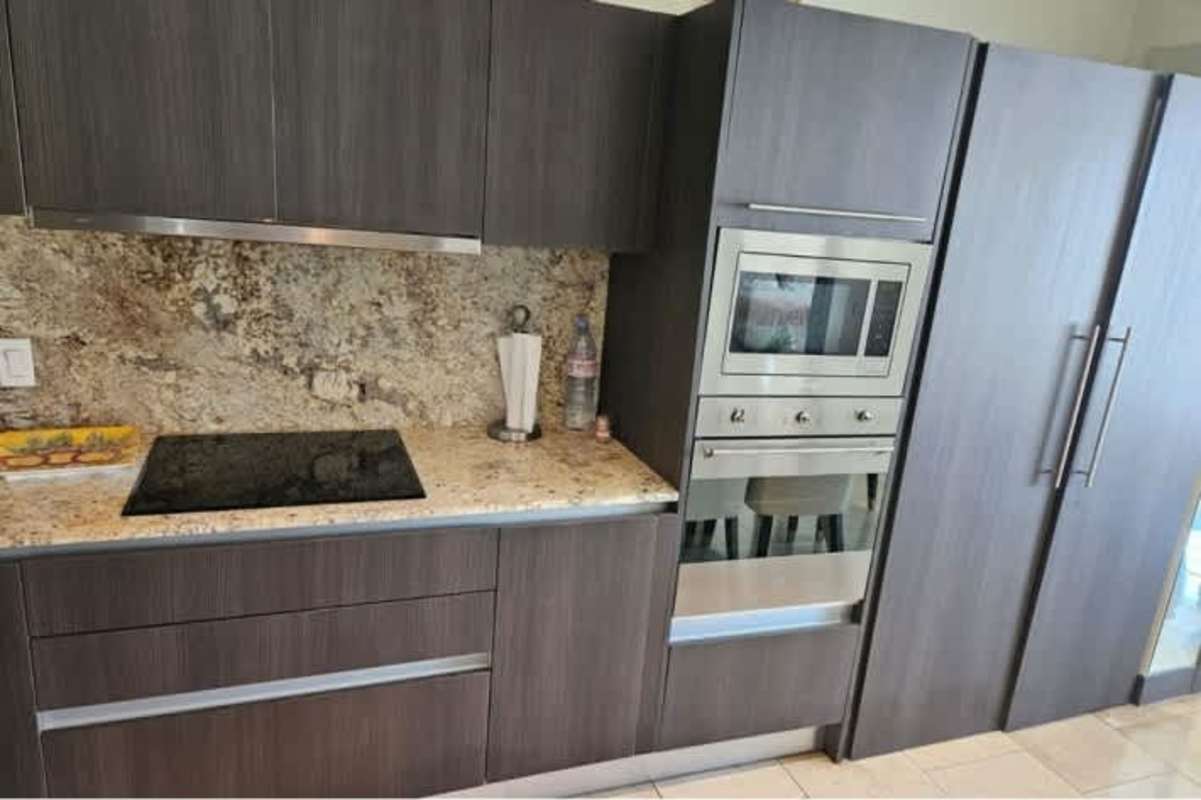 Beautifully furnished kitchen and dining area in PH TOC with granite, appliances and views of Panama City