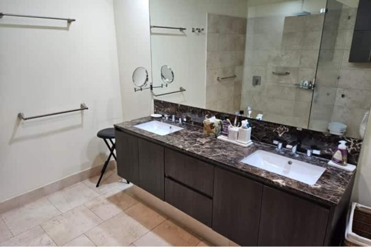Bathroom finished in marble countertops, glass-enclosed shower in PH TOC Panama City