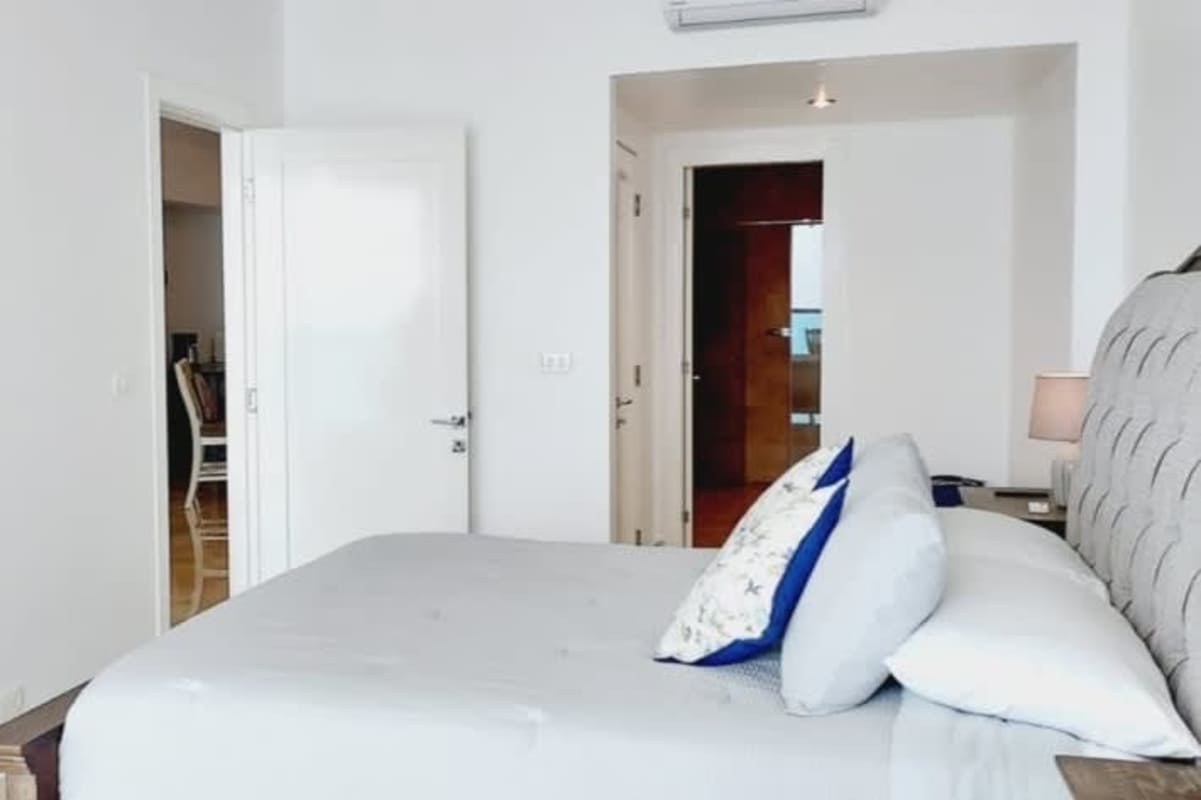 Luxury bedroom with walk-in closet and ocean view balcony access in PH Yoo Panama