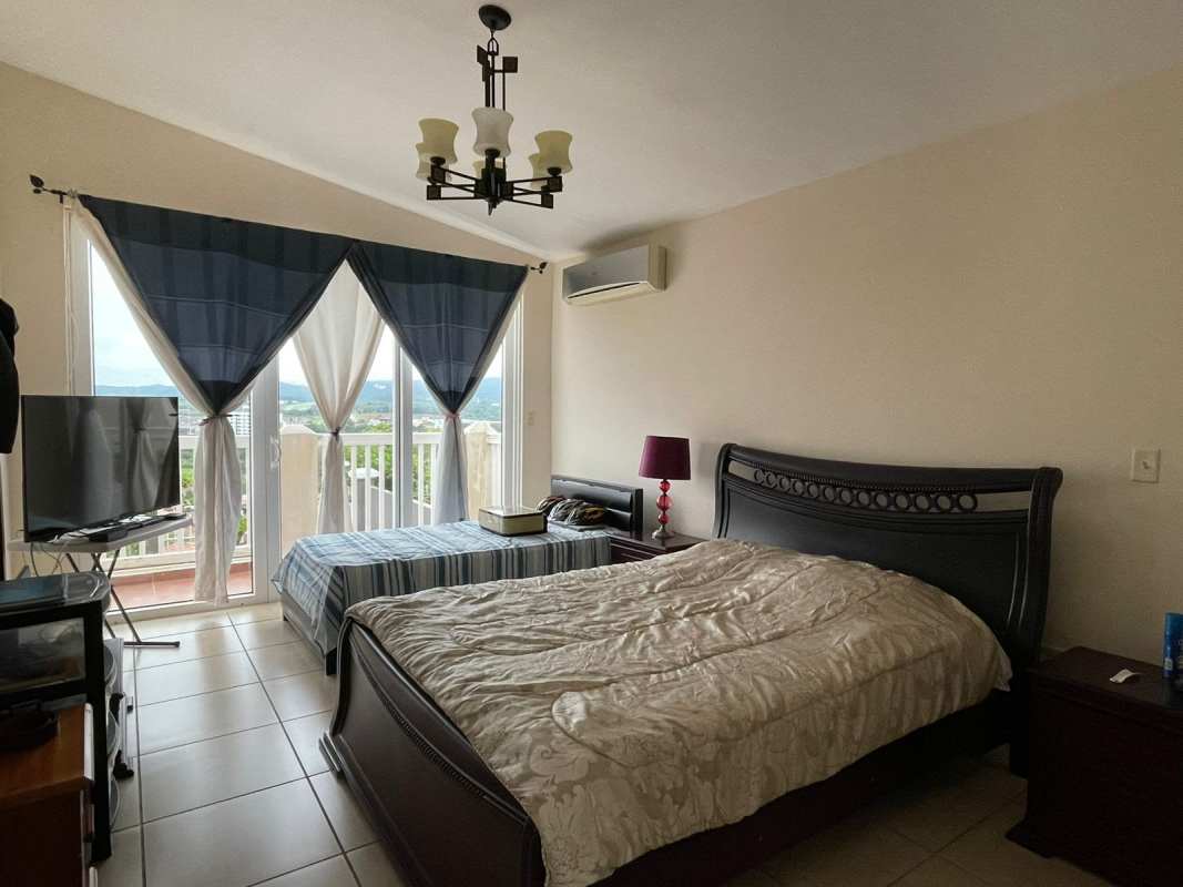 Spacious bedroom with tiled floor air conditioning and large windows PH Brisas Heights Brisas del Golf