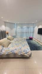 Modern furnished bedroom with large windows in Coronado Country Club Panama rental