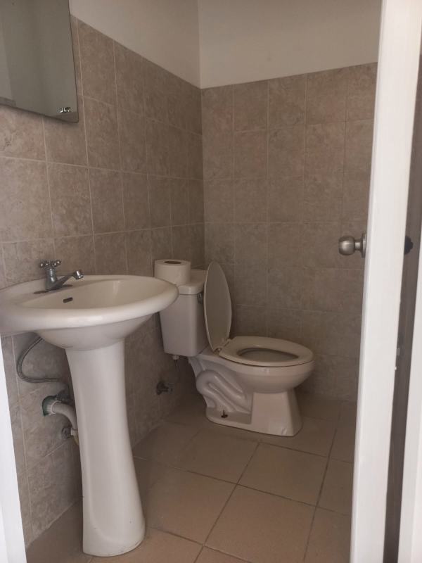 Simple bathroom pedestal sink toilet tiles in commercial rental La Loceria Betania Panama
