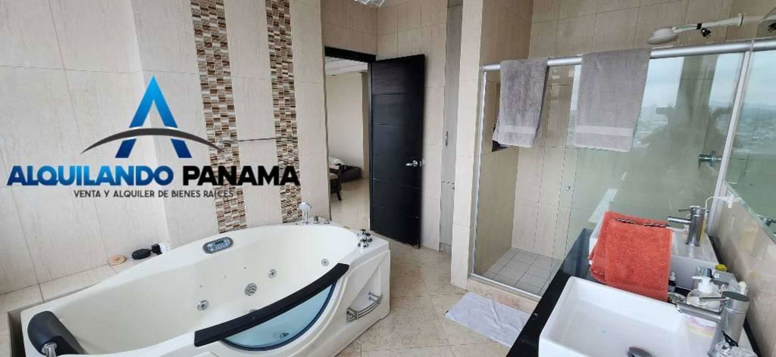 Master bathroom with Jacuzzi, glass-enclosed shower, double sinks and mosaic accents in PH Highland View Panama City