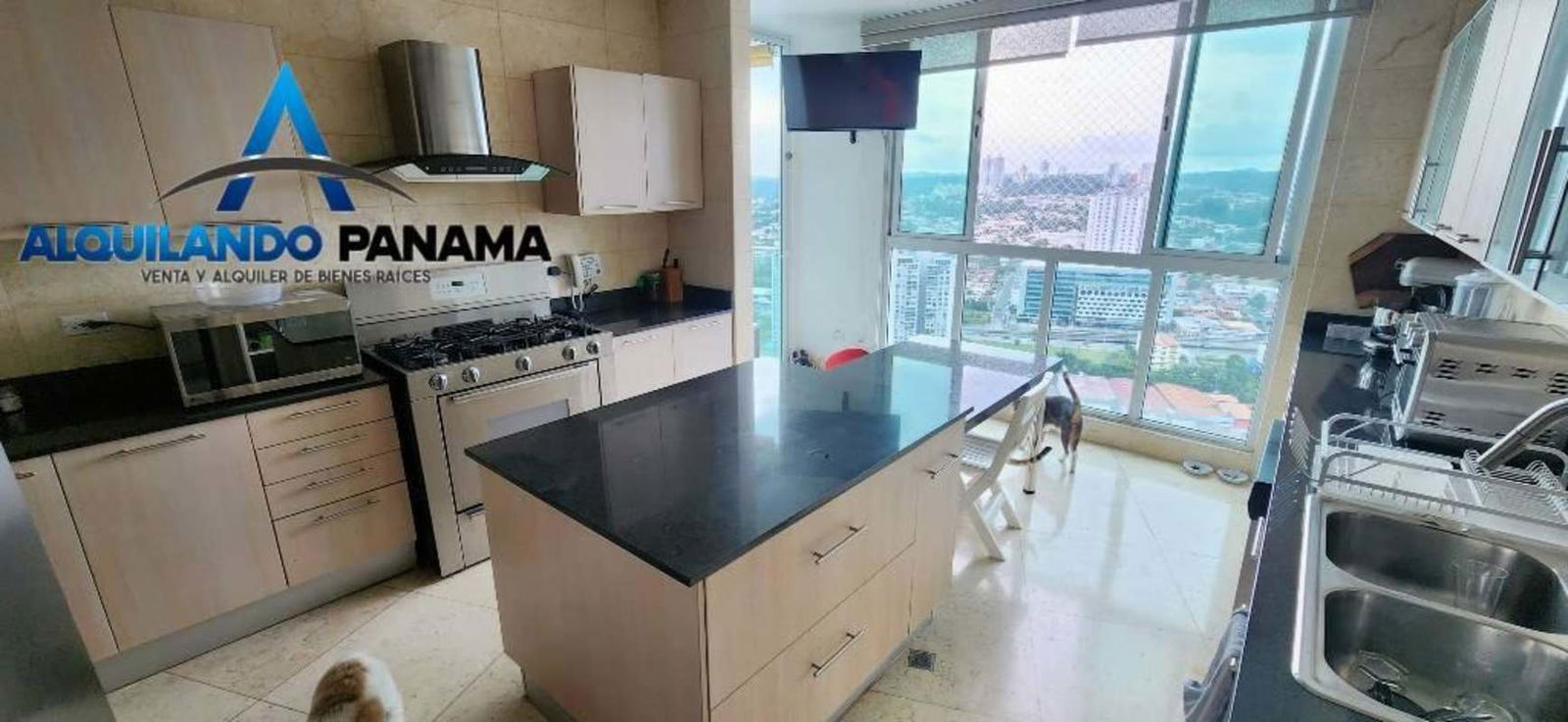 Spacious kitchen with island, granite tops, stainless appliances, and window views in PH Highland View Panama City