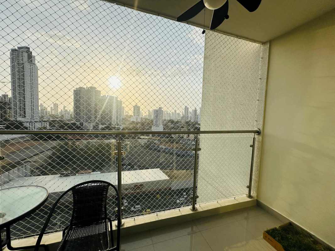 Living room with large windows, grey sofa, balcony access in PH Torre Delta Panama City
