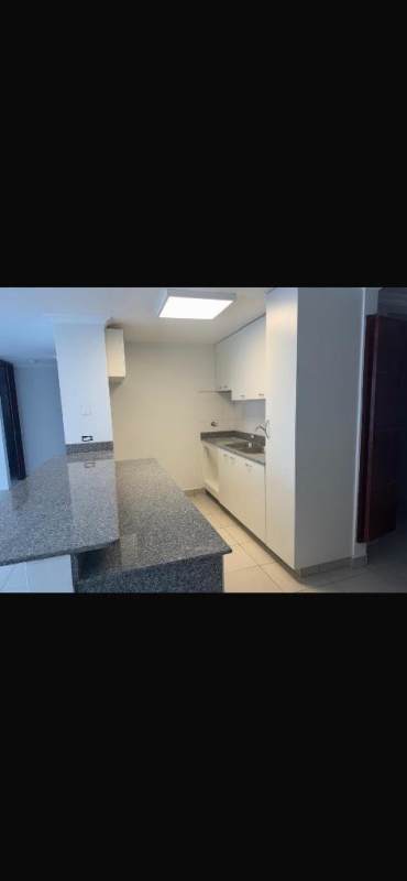 White kitchen with granite counters and overhead cabinets PH Central Park Panama City apartment