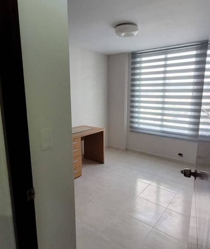 Minimalist small room or home office space with large window and zebra blinds PH McGregor Point Condado del Rey