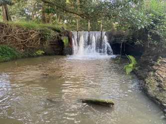 Aerial photo showing lakes, fields, buildings, and dirt road on 111 hectare ranch Panama