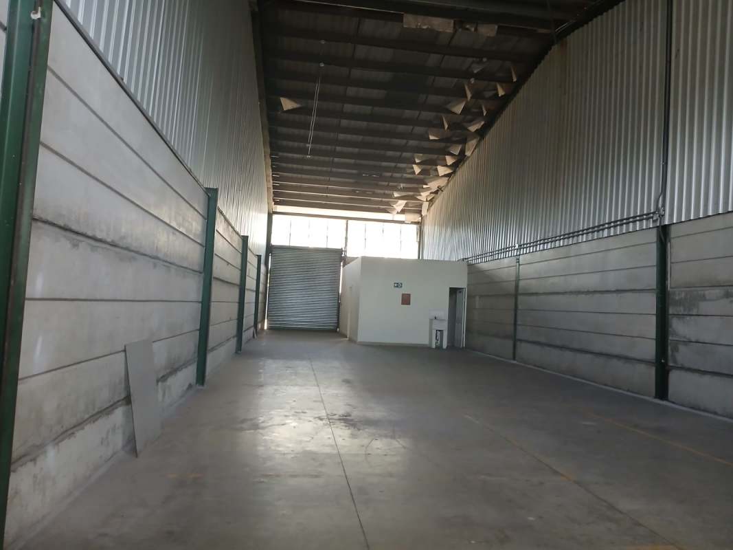 Industrial warehouse with small office partition and rolling shutter door in Villa Zaita
