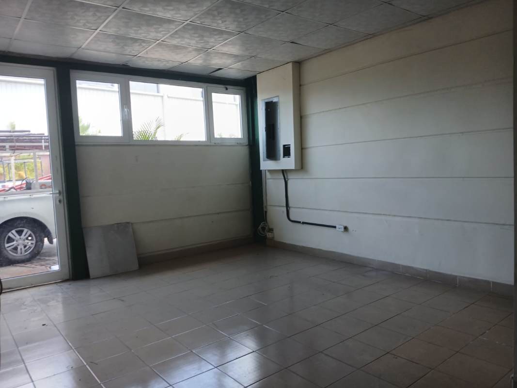 Empty interior room with tiled floor and windows inside industrial warehouse Villa Zaita Panama