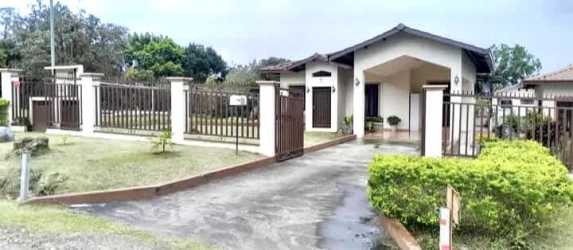 Bedroom with window, wooden closet, ceiling fan in new Alto Boquete house Panama