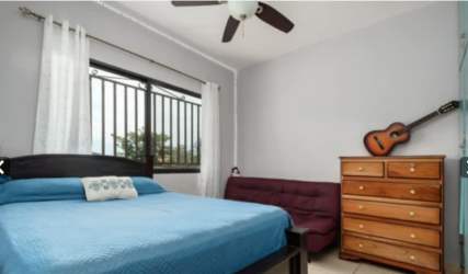 Kitchen featuring wooden upper cabinets, breakfast counter, ceramic tile backsplash new house Alto Boquete Panama