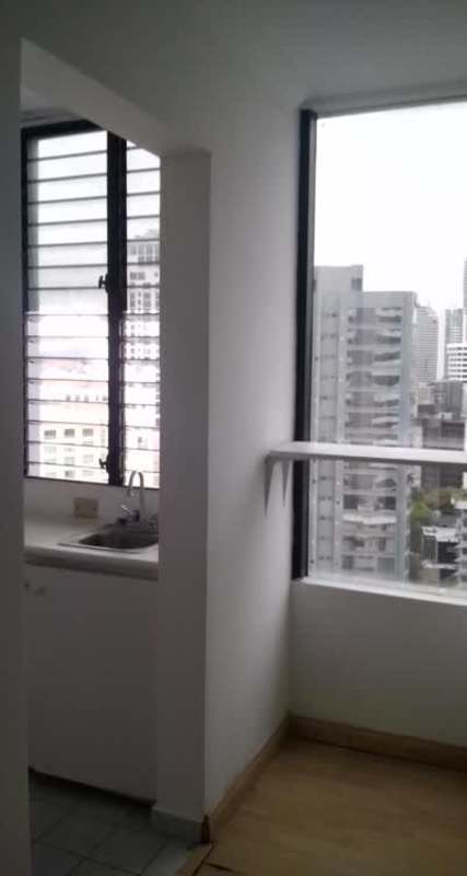 Bright kitchenette corner with large windows overlooking Panama City skyline inside PH BICSA Financial Center office
