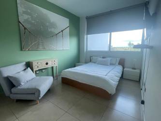 Infinity pools with bridge, beach access, green areas at Santa Clara Residences Panama