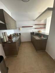 Modern kitchen with L-counter, overhead cabinets oceanfront condo Santa Clara Amanecer