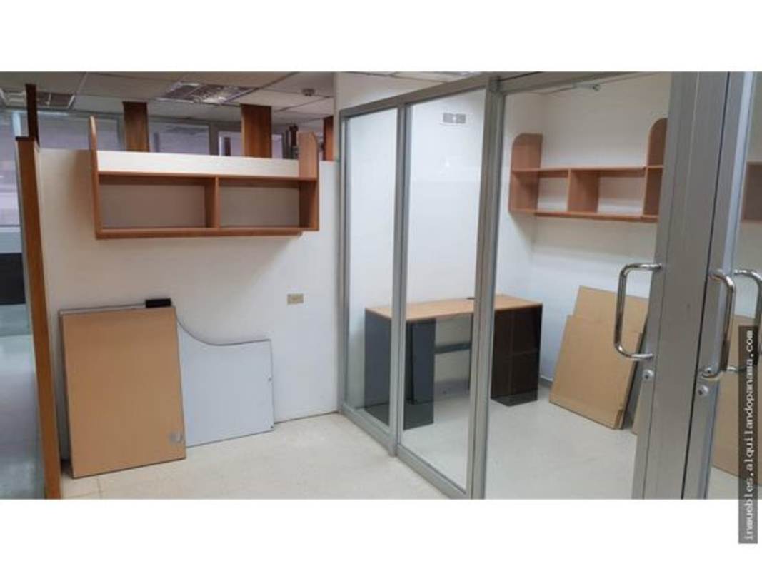 Modern office with glass partition door shelves desk neutral tile floor in Altos del Chase Business Center Panama City