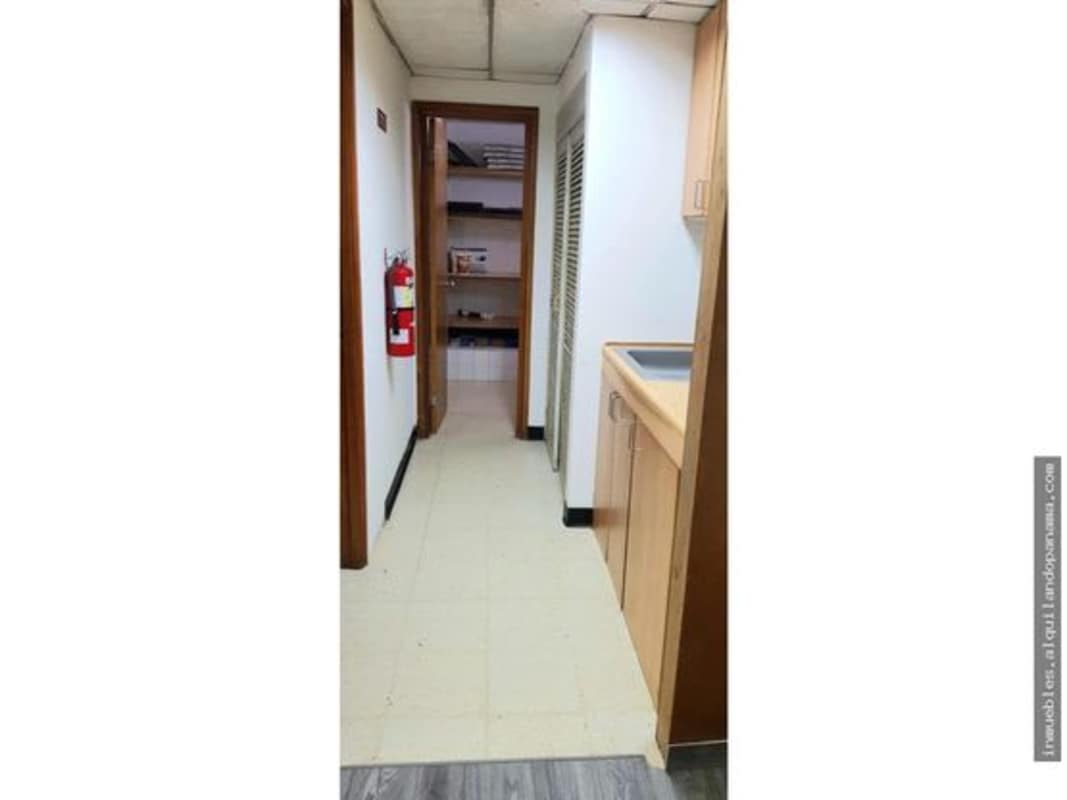 Small functional home office setup with built-in wooden desk shelves at Altos del Chase Betania Panama