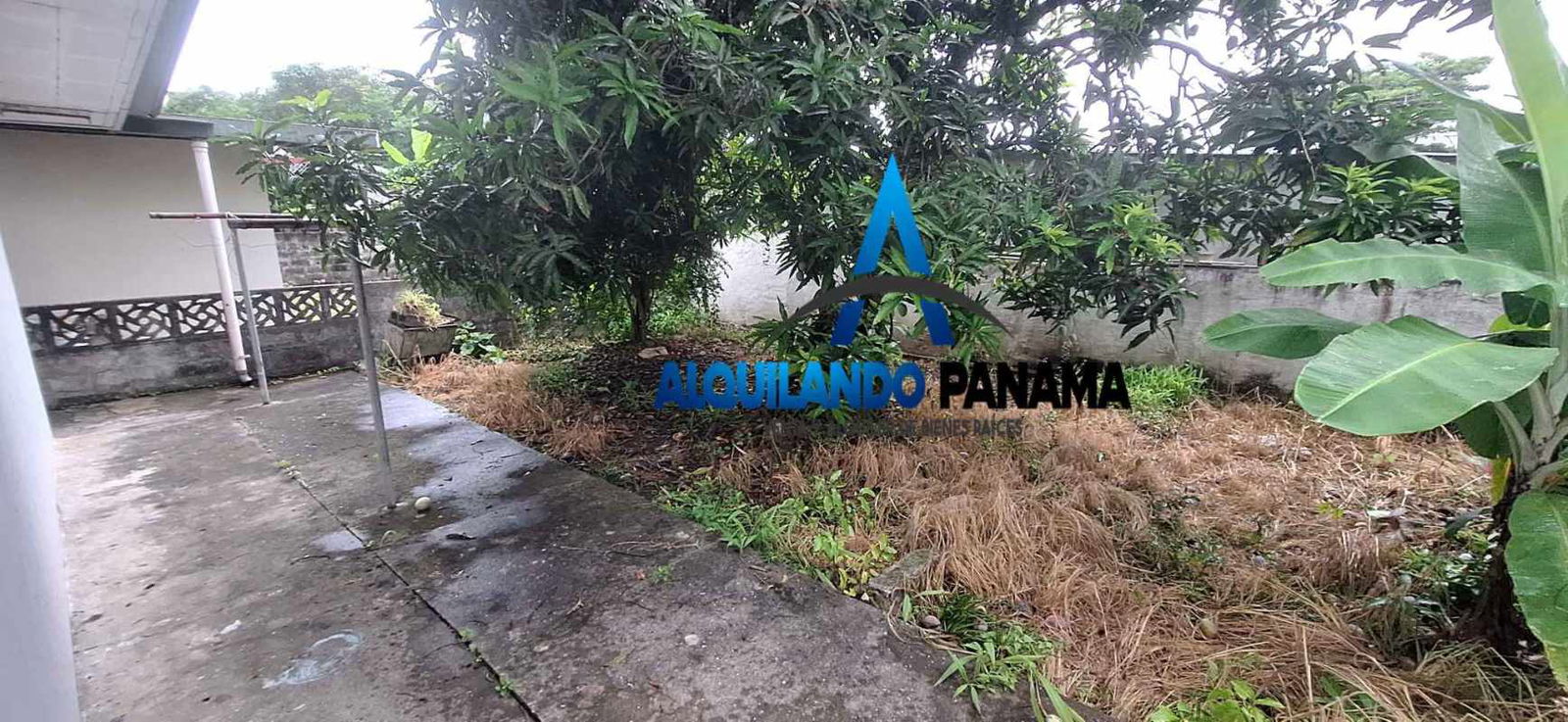 Carport with tiled floor arched openings secure gate Panama City house for sale