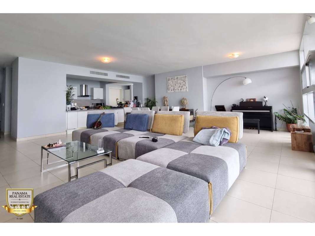 Bright living dining room floor-to-ceiling windows with Pacific Ocean views at PH Waters on the Bay Panama