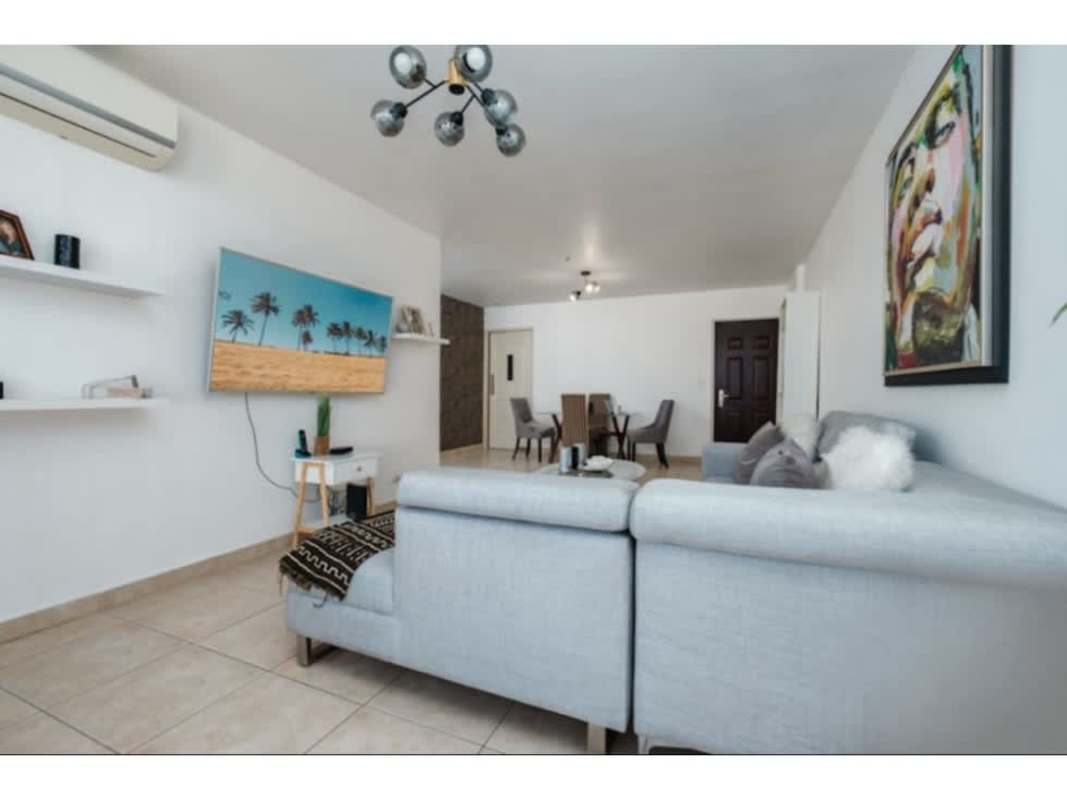 Kitchen and laundry area in apartment with wood cabinetry and tiled backsplash PH San Francisco Bay Panama