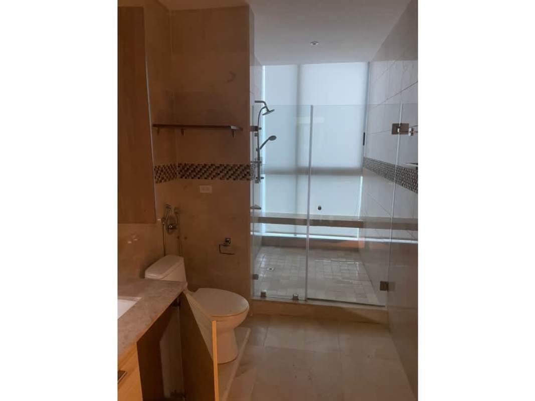 Bathroom with glass shower, beige ceramic tile walls, mosaic accents PH Punta Paitilla