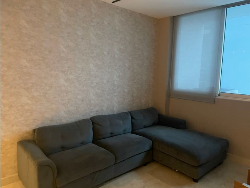 Minimalist living room with L shaped sofa, textured wall, large window PH Punta Paitilla