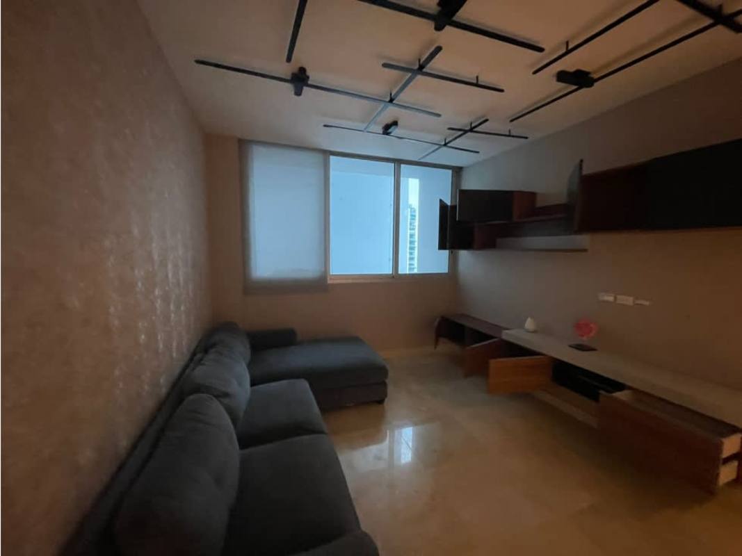 Stylish living room with sectional sofa, built-in shelving, panoramic window PH Aventura Tower Panama