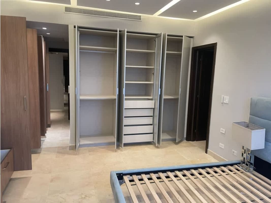 Modern walk-in closet with open shelves, drawers, hanging space PH Punta Paitilla