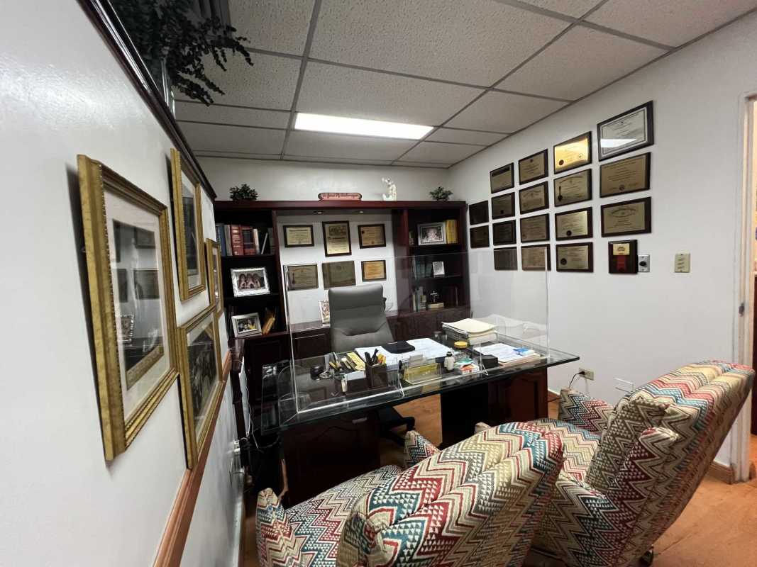 Executive medical office interior with certificates, bookshelf, artwork in Punta Paitilla Panama