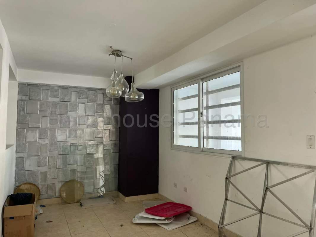 Dining space with accent wall and pendant lamp in Limajo Panama City