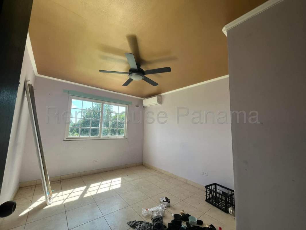 Bedroom with large window, fan, AC unit in Limajo Panama house