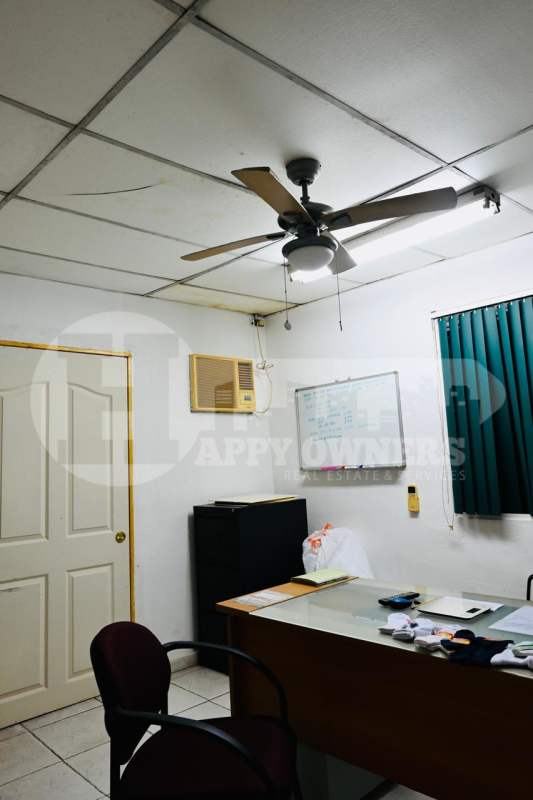 Small private office with ceiling fan, glass-top desk, AC unit and blinds in Pueblo Nuevo Panama