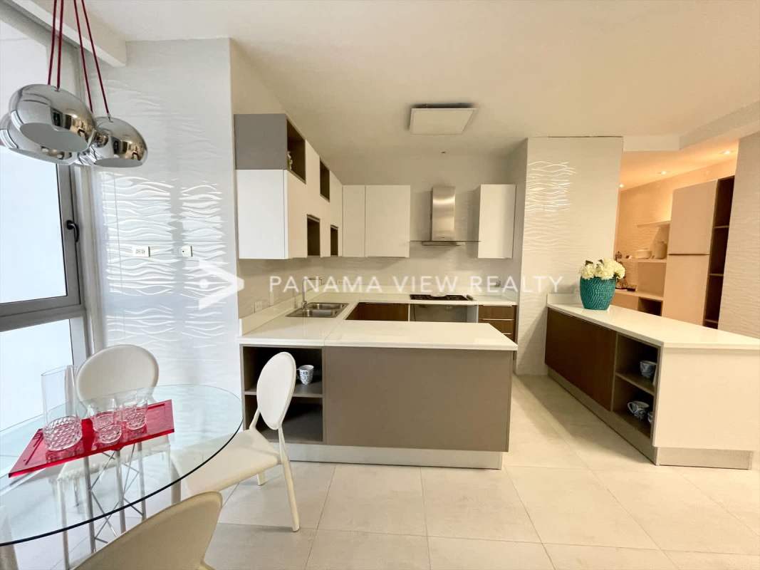 Contemporary kitchen with marble counters and island at PH Regalia Costa del Este Panama