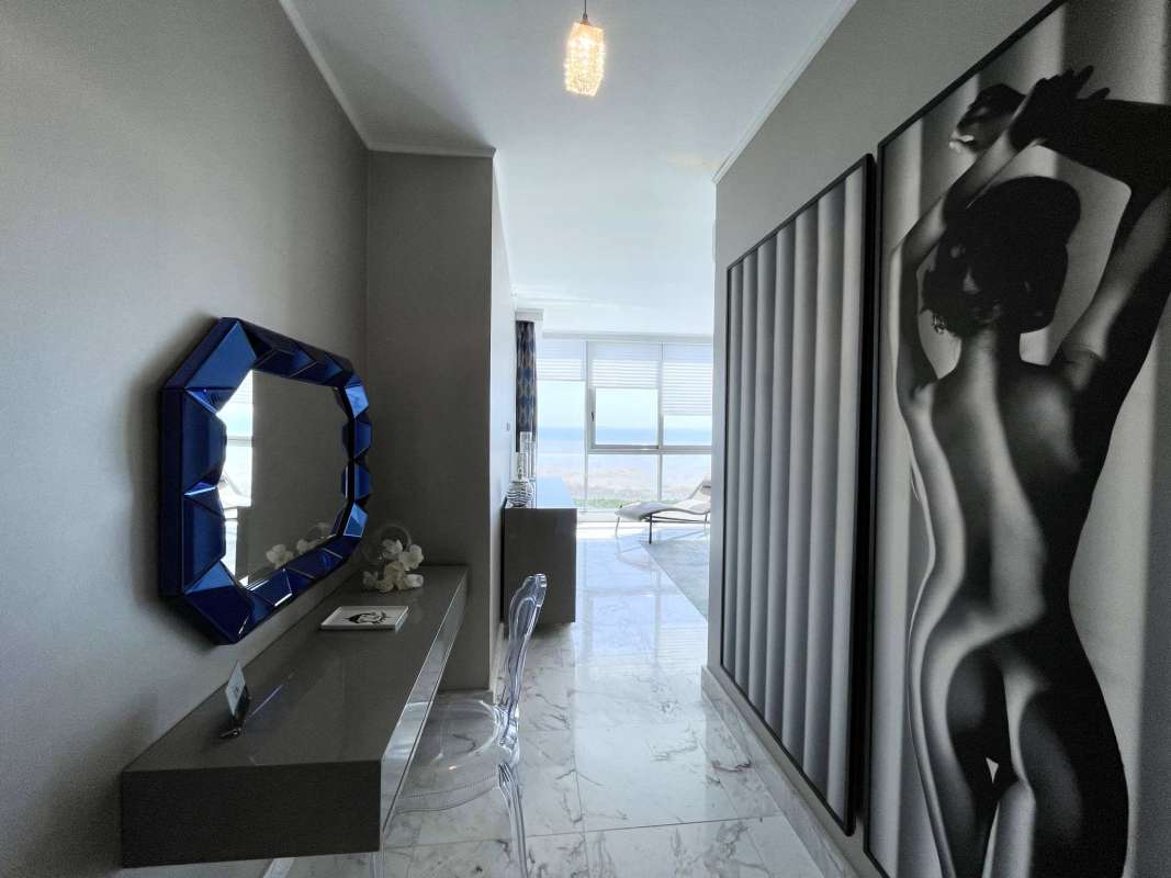 Modern hallway with marble floors, artistic mirrors, bright lighting in PH Regalia Costa del Este Panama City