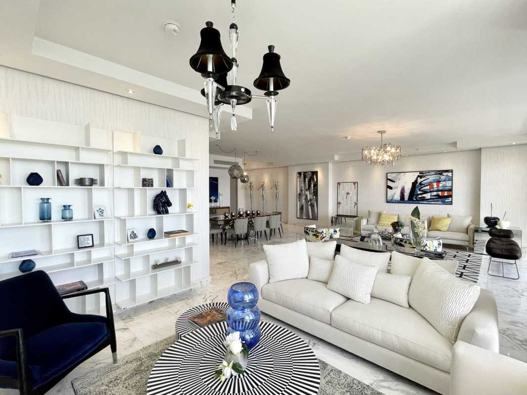 Spacious modern living and dining room with marble floors, floor-to-ceiling windows, stylish décor in PH Regalia Costa del Este Panama