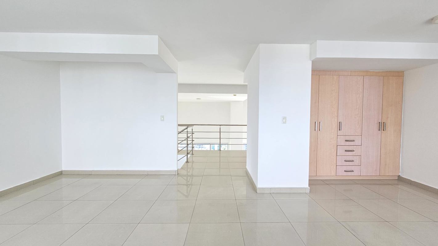Modern mezzanine with metal railings and natural light at duplex loft in Costa del Este Panama City
