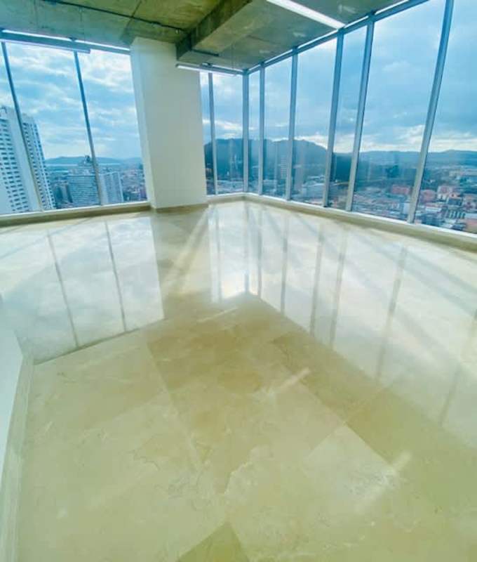 Empty office space with glass corner windows overlooking city and ocean at Balboa Office Center Panama