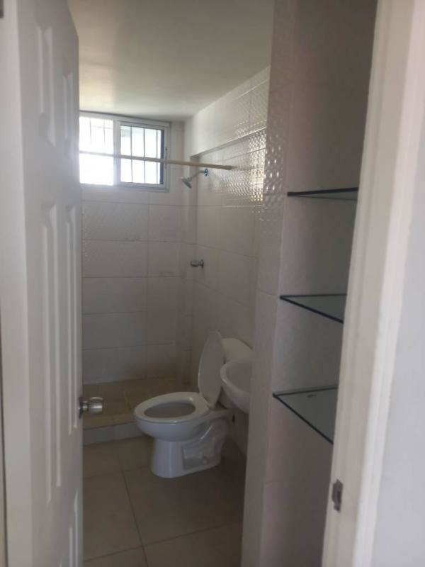 White minimalist bathroom with window, toilet, sink, shower in PH San Judas Parque Lefevre Panama
