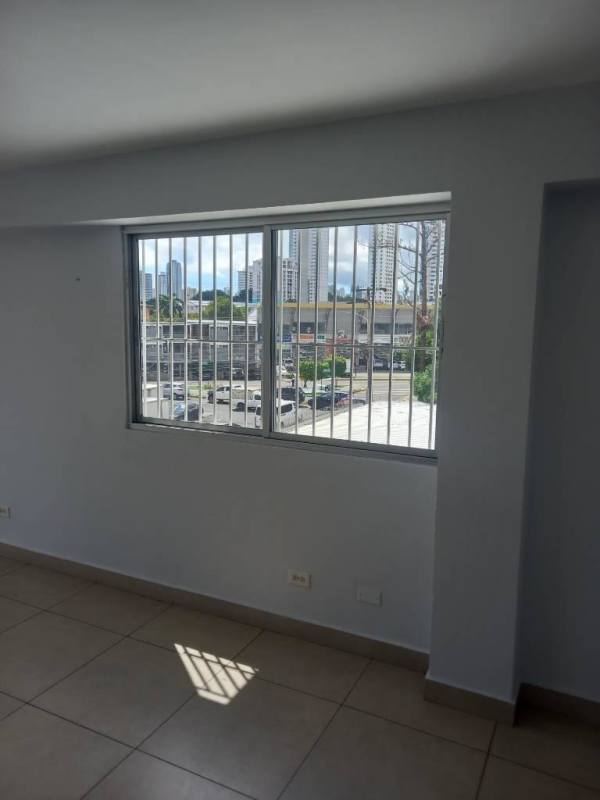 Bright living and bedroom area with ceramic floor, window and balcony at PH San Judas in Parque Lefevre Panama City