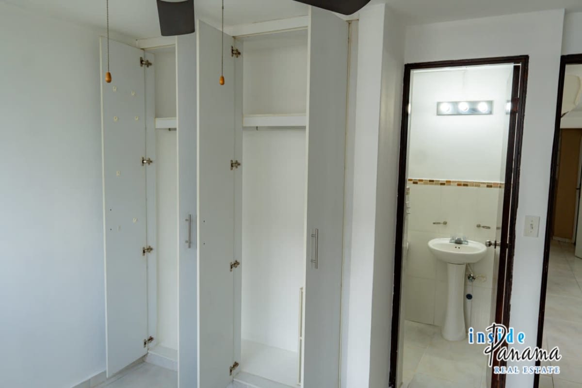 Empty bedroom with closet, ceiling fan and large window in PH Llano Bonito Panama