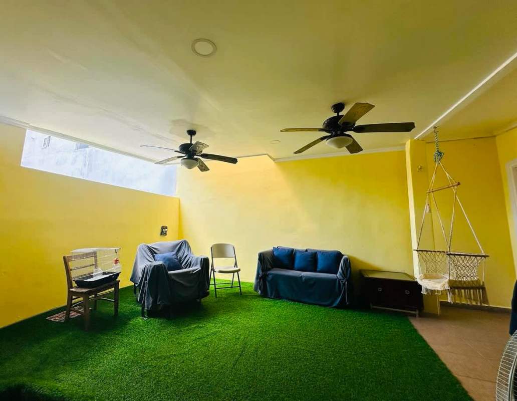 Family living space with staircase, sofas, tiled floor Panama