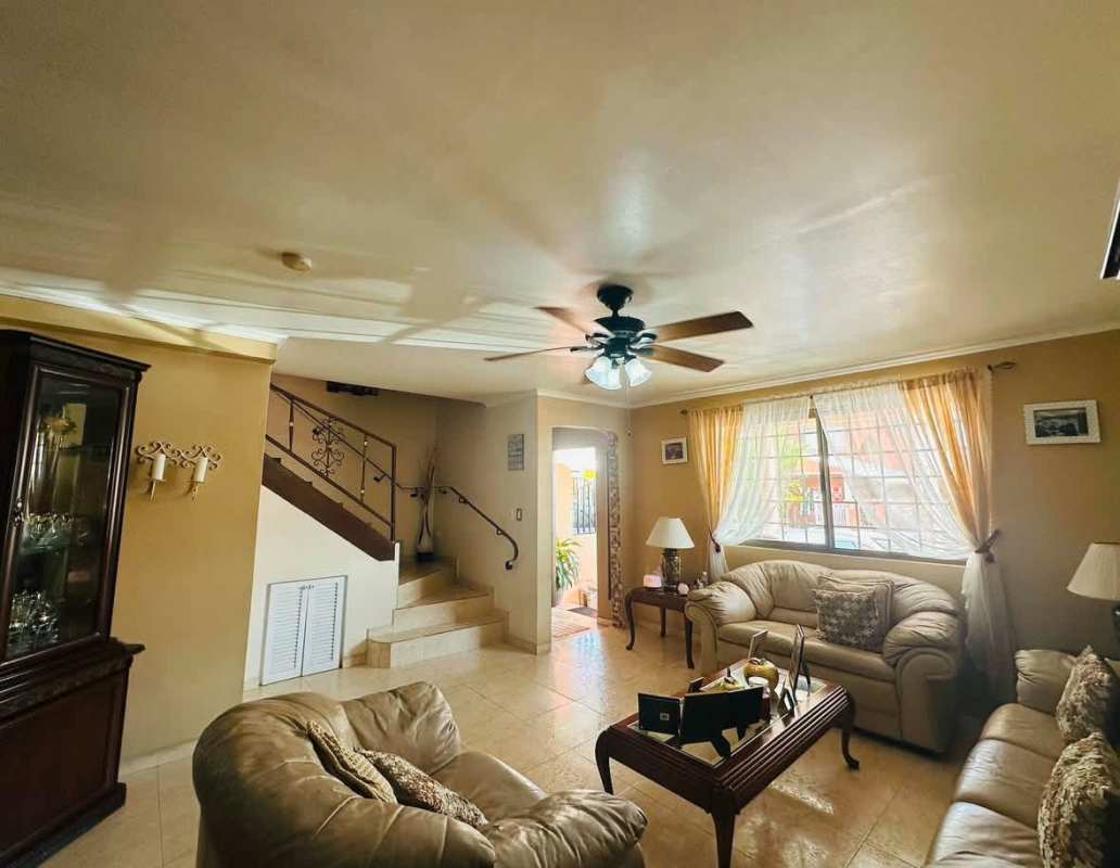 Cozy living room with sliding glass door to terrace, beige sofas Cerro Viento