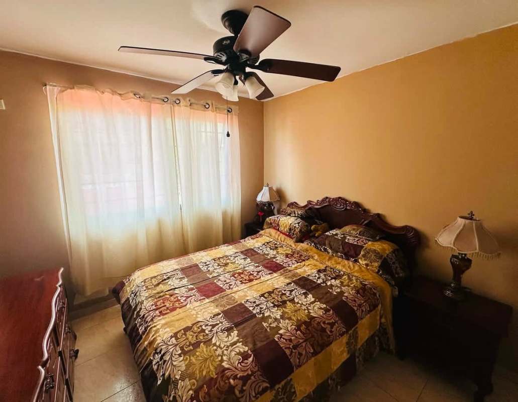 Simple bedroom with window, fan, cozy style Panama