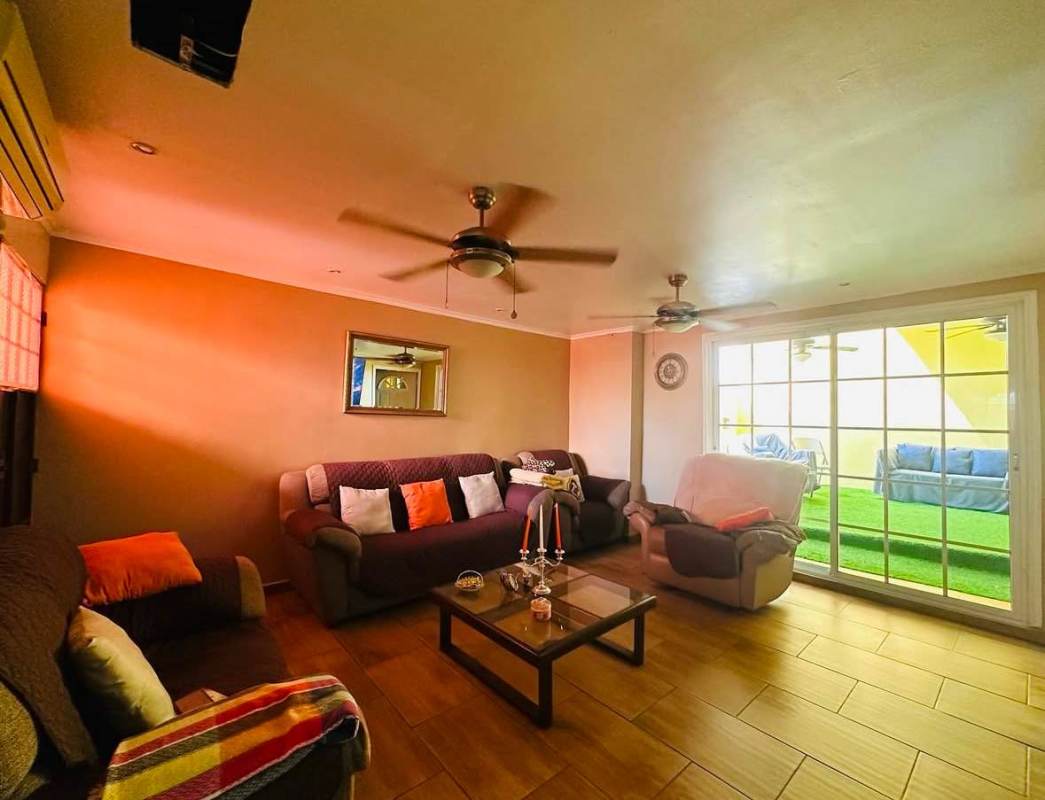 Bedroom with ornate wood headboard, ceiling fan, window light Cerro Viento