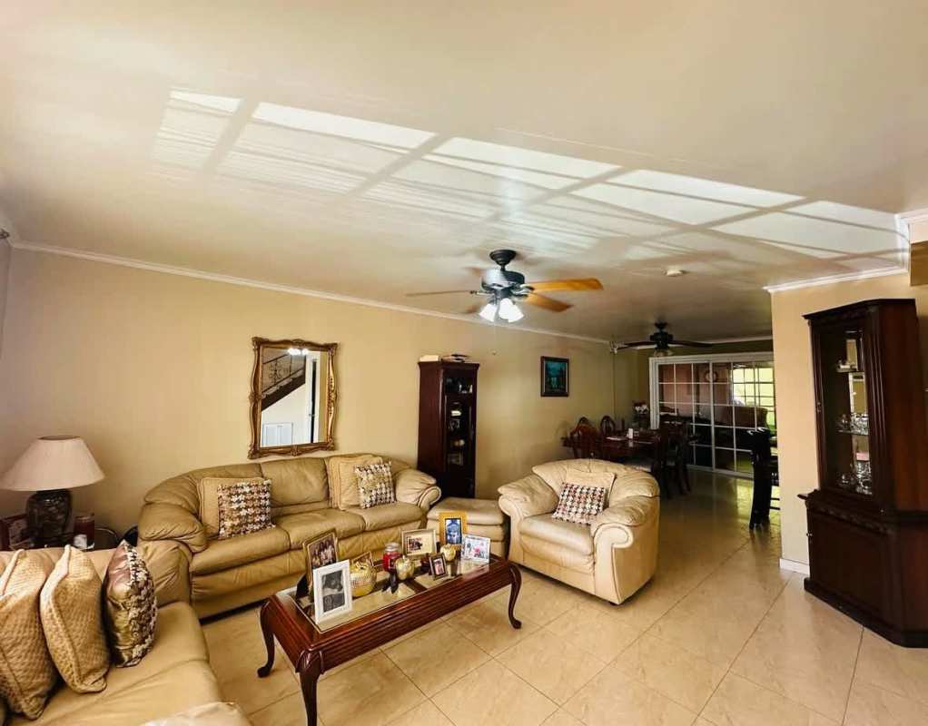 Traditional open-plan living and dining room with windows and fans Panama