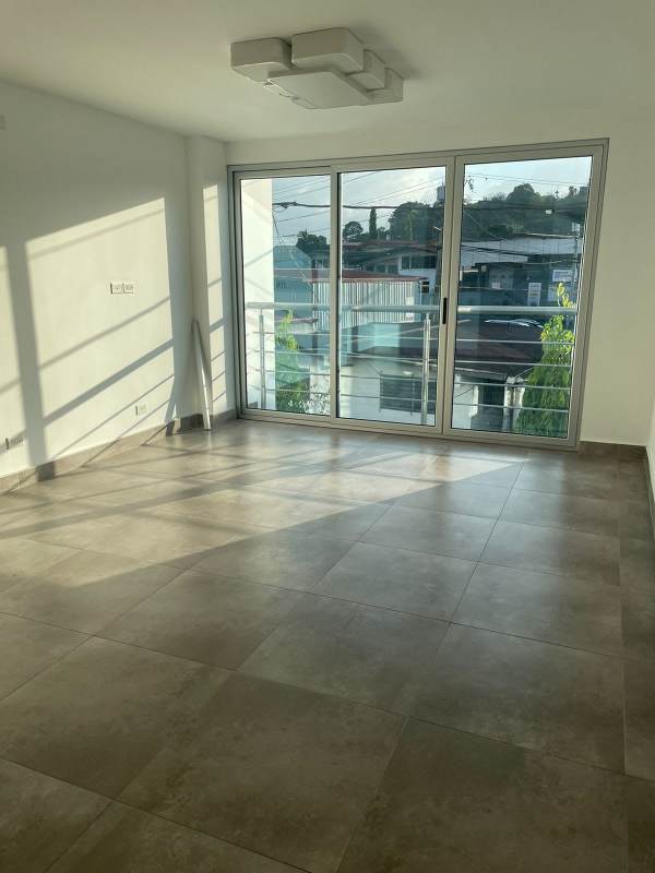 Living room with large windows and view balcony PH Arsema Villa Cáceres Panama