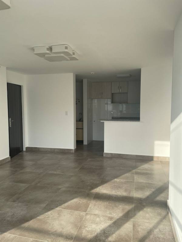 Bright living room with open kitchen design and tile floor PH Arsema Betania Panama