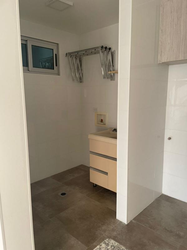 Laundry space with cabinet sink and retractable rack PH Arsema apartment Panama
