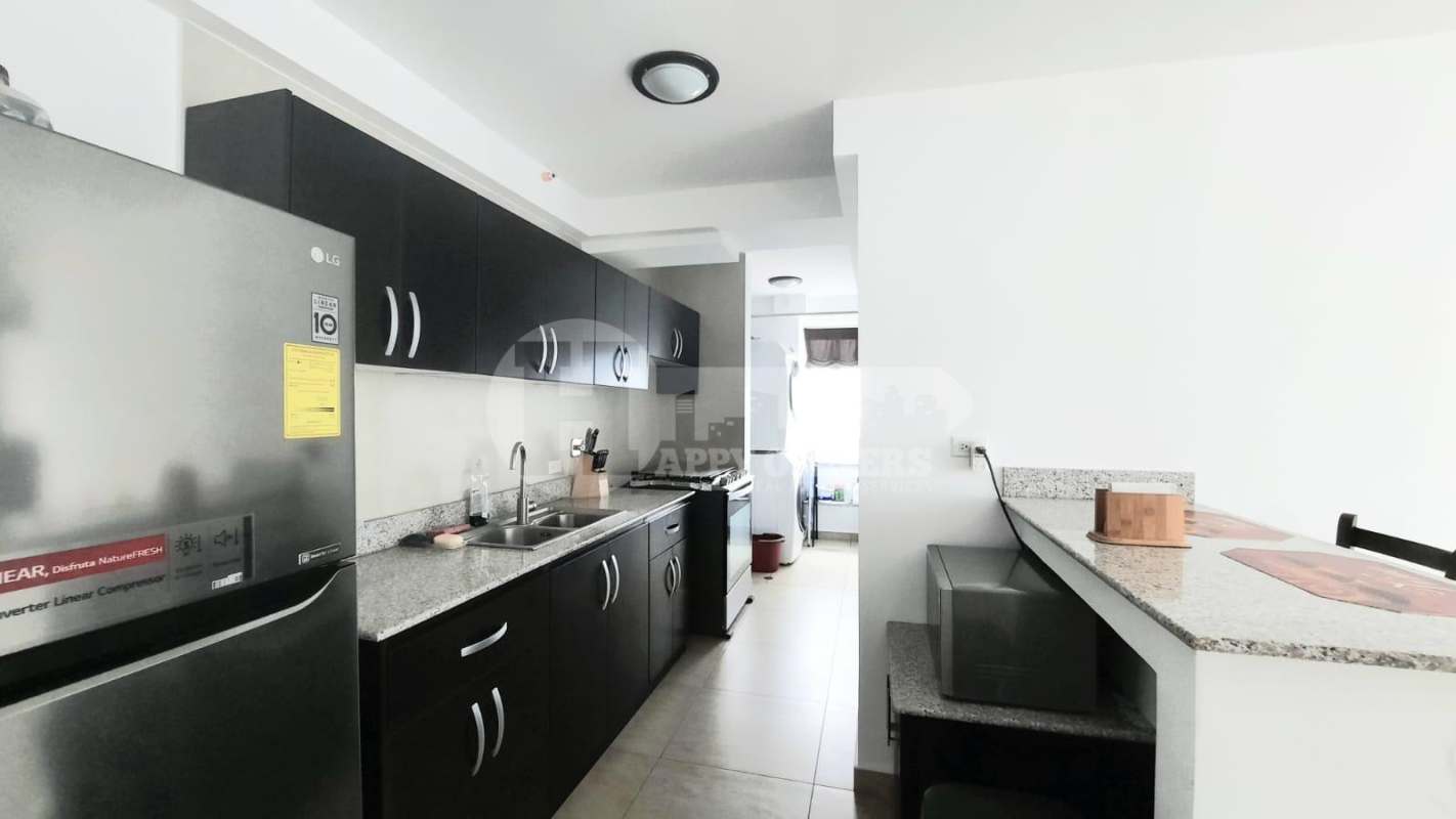 Modern bedroom with purple bedding built-in closet large corner windows PH Vista Park Panama