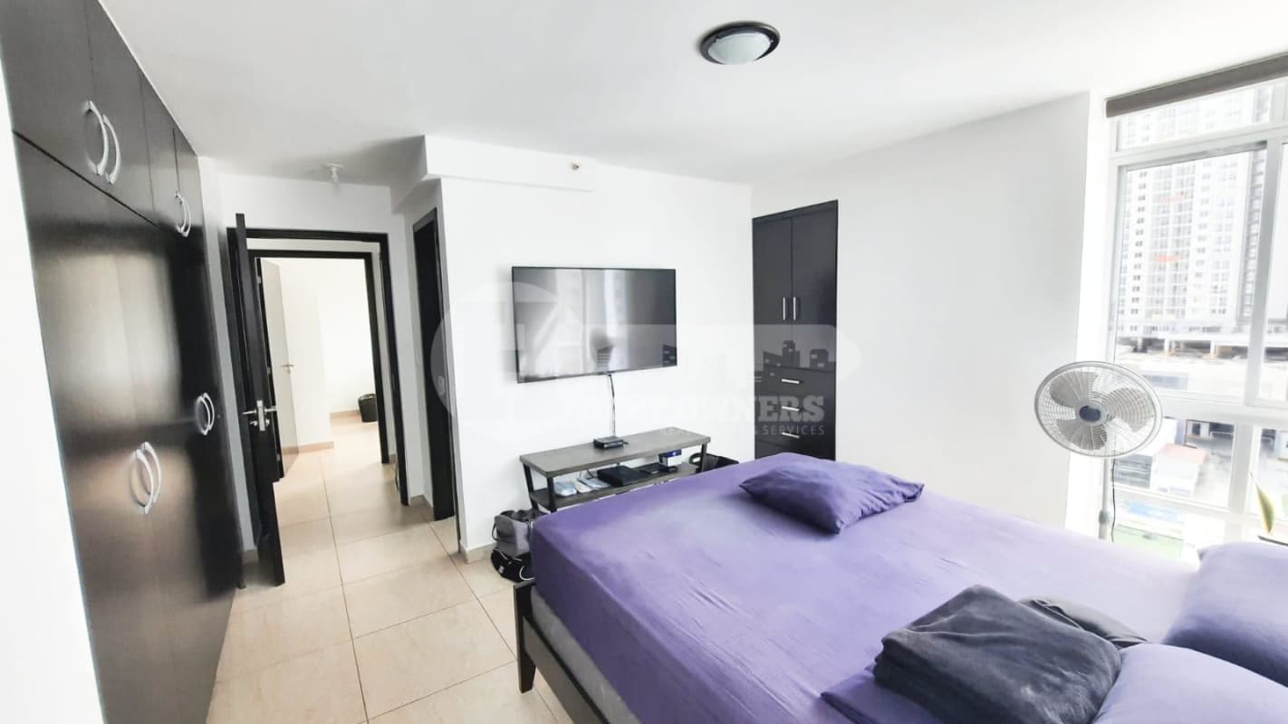 Bedroom purple bedding wall mounted TV built-in closets PH Vista Park Panama